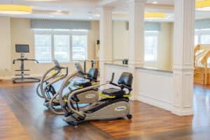 Rehab gym with three recumbent bikes and a therapy machine at Anchor Post Acute.