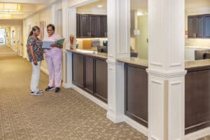 two nurses in front of the nurse's station at the Anchor Post Acute facility