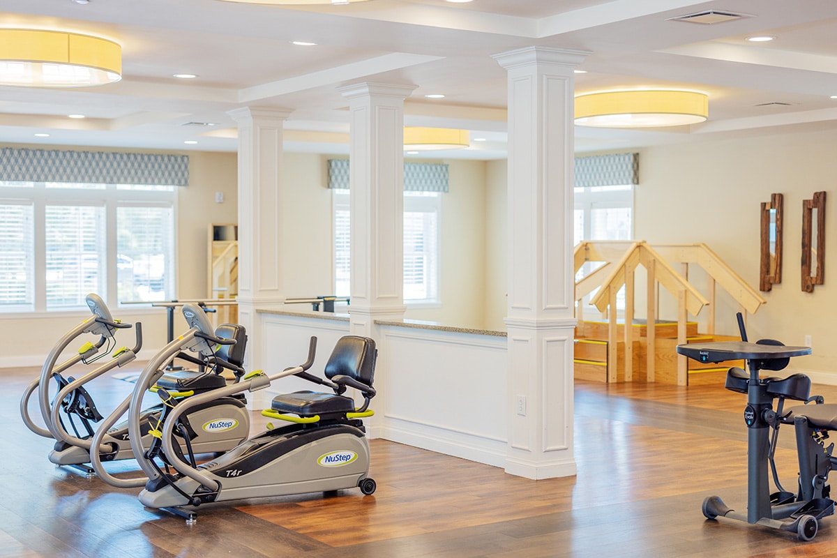 Rehab gym with two recumbent bikes and a therapy staircase at Anchor Post Acute.