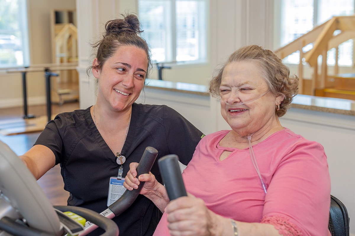 a rehab therapist and a resident in the rehab gym at the Anchor Post Acute facility