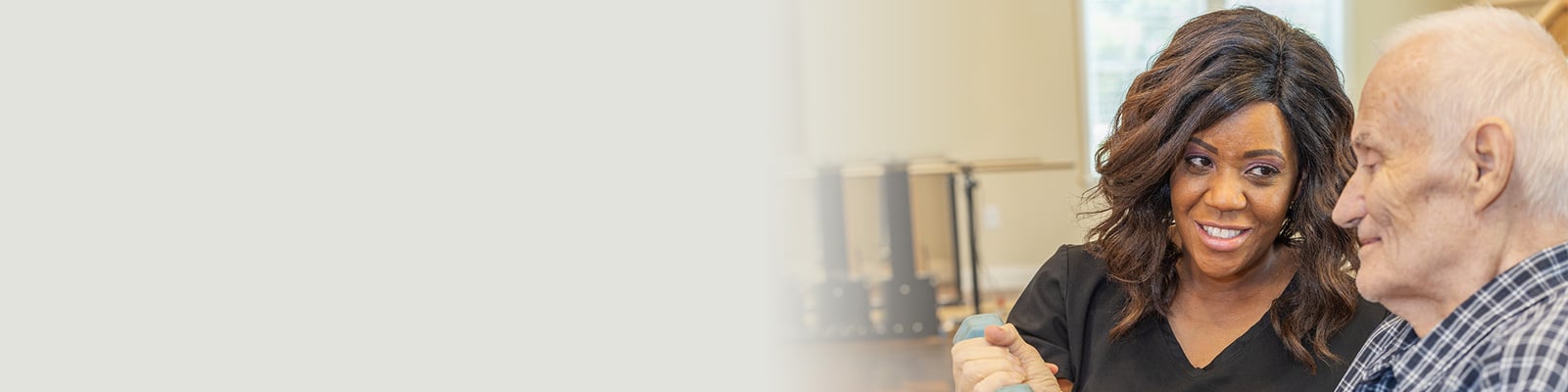 a rehab therapist and a resident in the rehab gym at the Anchor Post Acute facility
